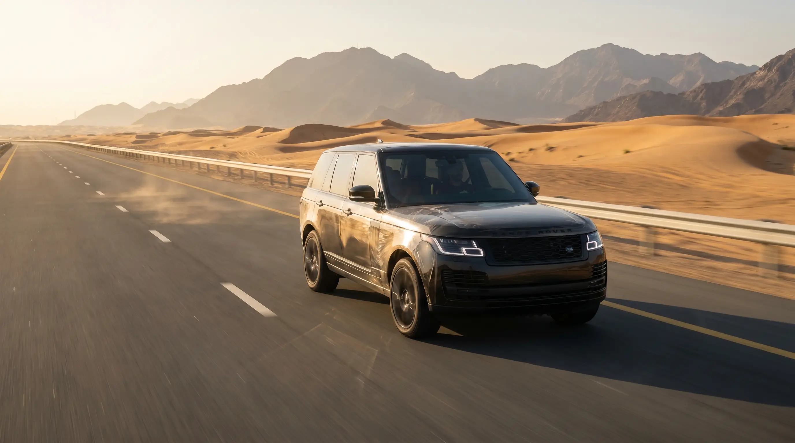Luxury SUV protected with PPF driving on a UAE highway near Fujairah